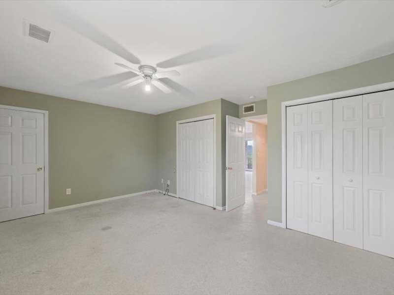 26 Cooper Road, Unit 306 Poughkeepsie, NY 12603 - Photo 7 of 16 an empty room with closet and a ceiling fan