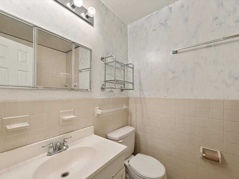 26 Cooper Road, Unit 306 Poughkeepsie, NY 12603 - Photo 9 of 16 a bathroom with a sink a toilet and shower