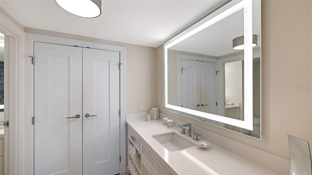 240 Sands Point Road, Unit 4206 Longboat Key, FL 34228 - Photo 17 of 41 a bathroom with a sink and mirror with toilet