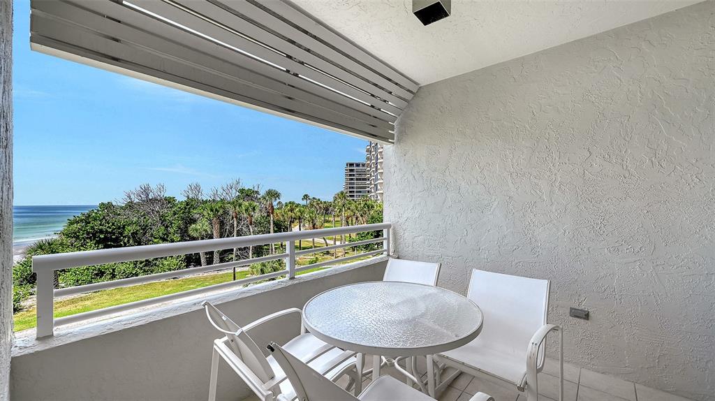 240 Sands Point Road, Unit 4206 Longboat Key, FL 34228 - Photo 9 of 41 a view of a chairs and table in the balcony