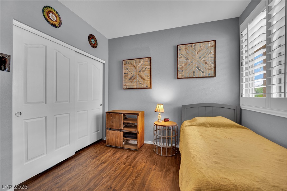 1724 Millstream Way Henderson, NV 89074 - Photo 20 of 60 Hardwood floors and bright window light define this inviting bedroom space.