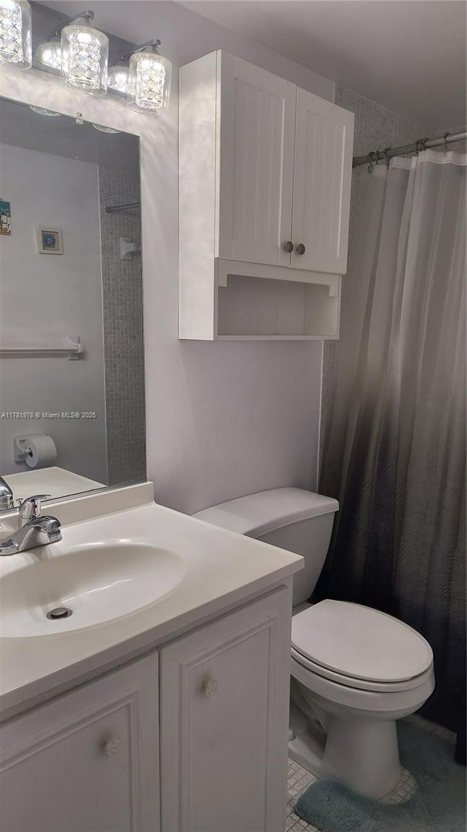 4500 North Federal Highway, Unit 352F Lighthouse Point, FL 33064 - Photo 11 of 32 a bathroom with a sink a toilet and vanity