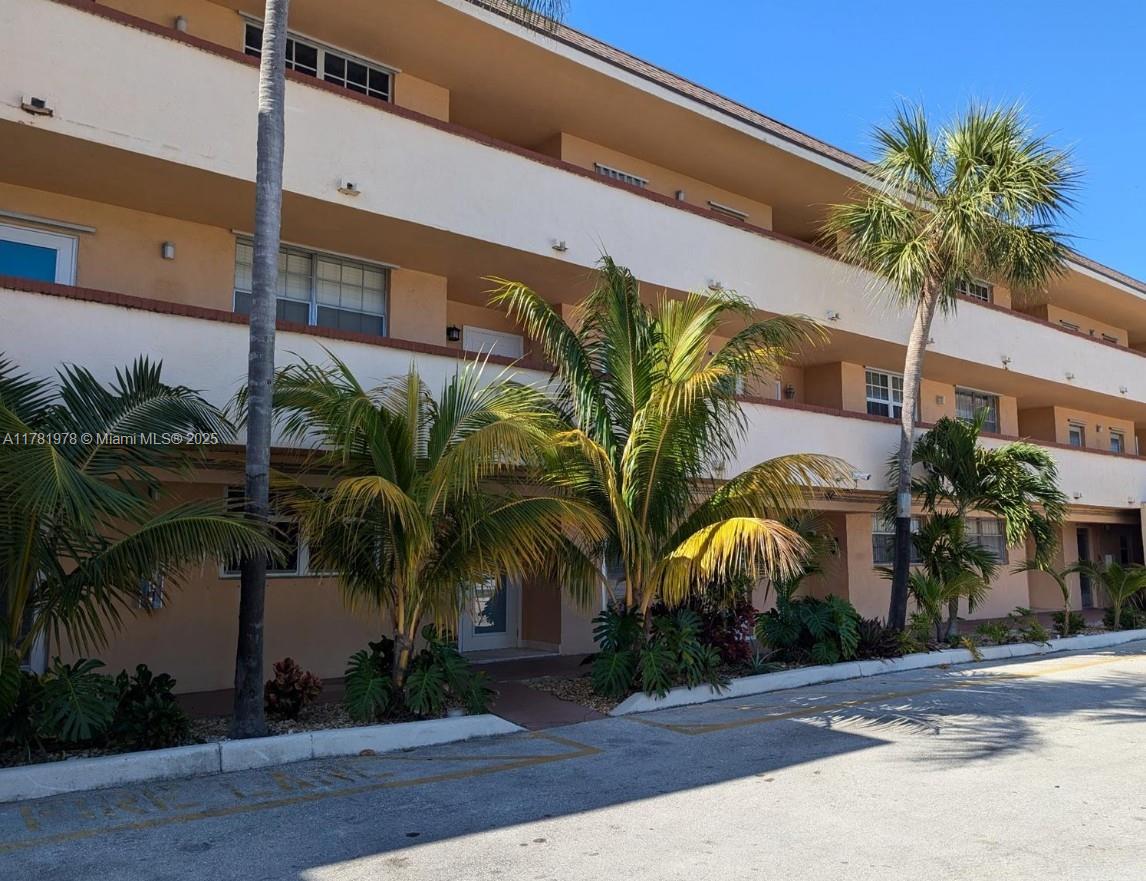 4500 North Federal Highway, Unit 352F Lighthouse Point, FL 33064 - Photo 22 of 32 a view of palm trees in front of a building