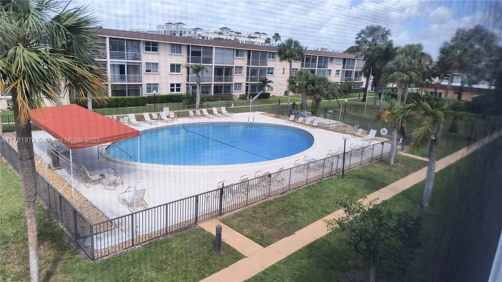 4500 North Federal Highway, Unit 352F Lighthouse Point, FL 33064 - Photo 27 of 32 a view of a swimming pool with a yard and plants
