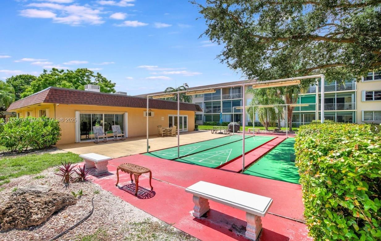 4500 North Federal Highway, Unit 352F Lighthouse Point, FL 33064 - Photo 29 of 32 a view of a backyard with sitting area and slide