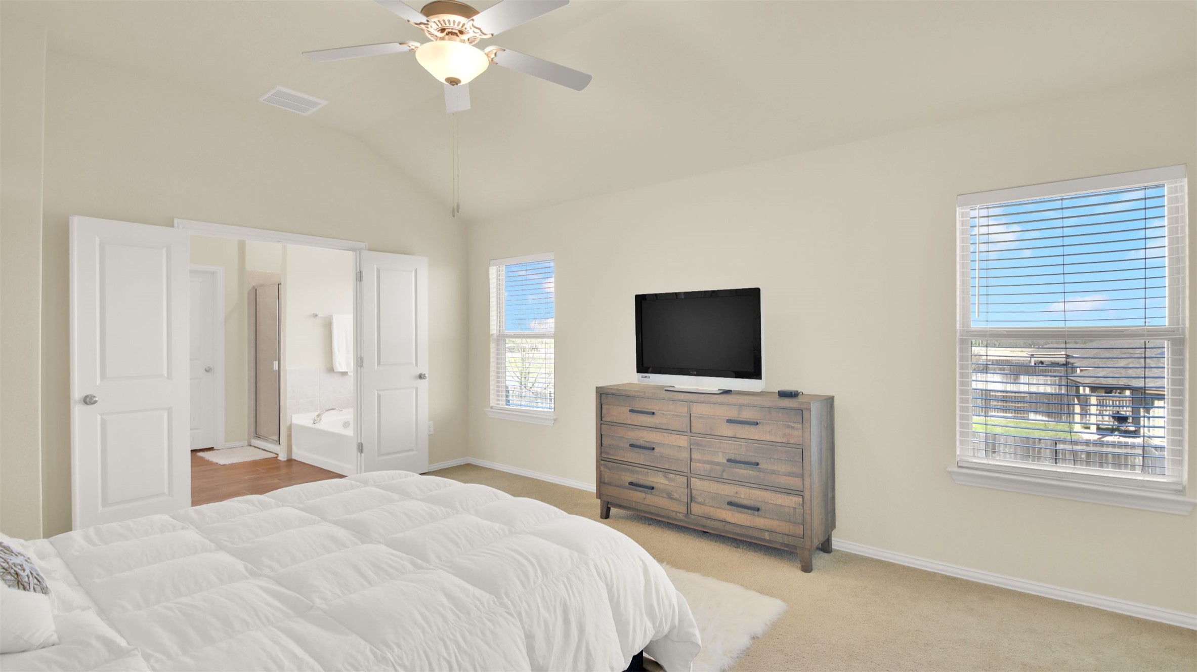 13716 Sugar Bush Path Manor, TX 78653 - Photo 35 of 37 Bedroom featuring light carpet, ensuite bath, a ceiling fan, and vaulted ceiling