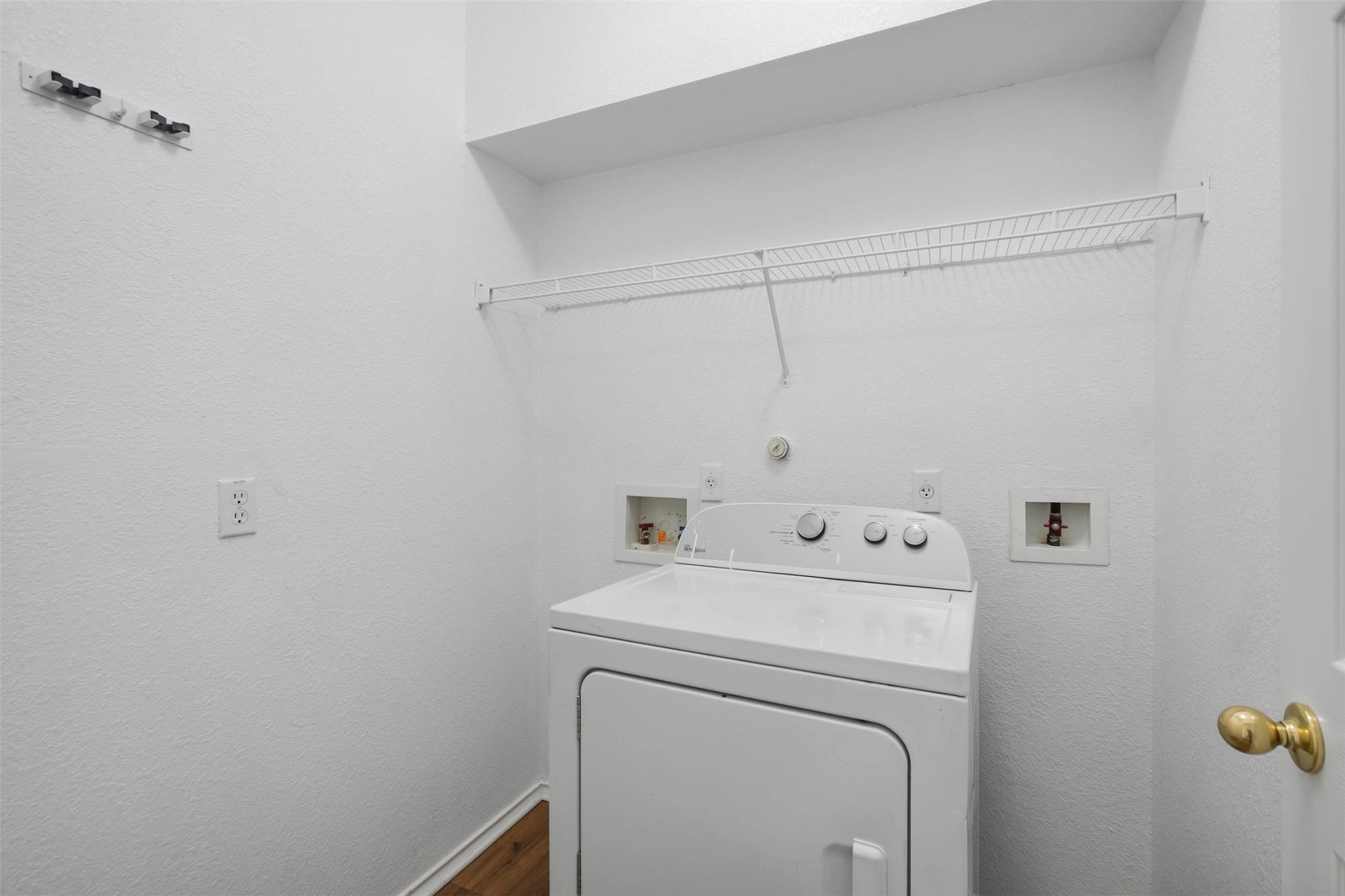 13808 Harris Ridge Boulevard, Unit B Pflugerville, TX 78660 - Photo 13 of 33 A dedicated laundry space is complete with built-in wire shelving and durable wood flooring.