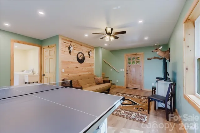 a bedroom with furniture and a large window