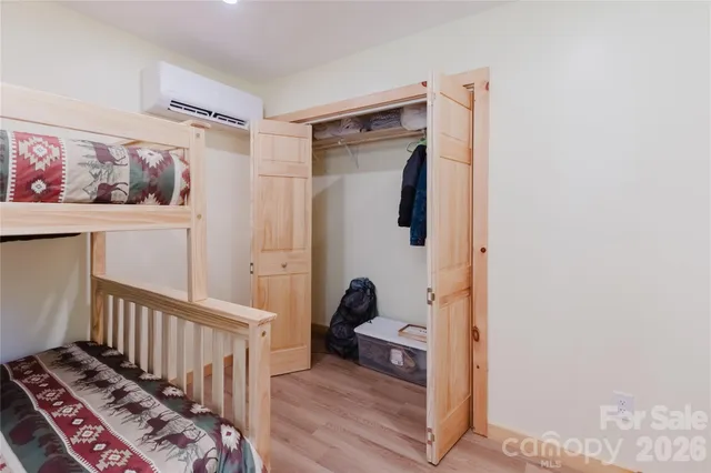 a bedroom with a bed and a chandelier