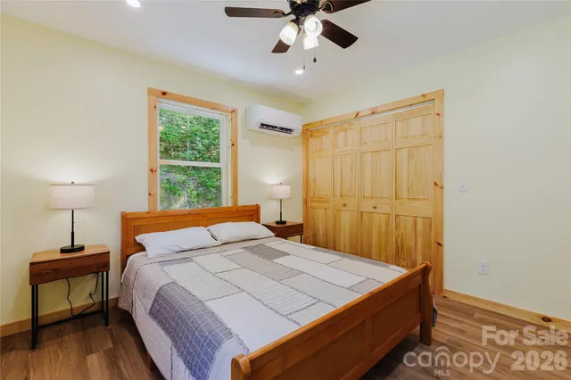 a bedroom with a bed and a chandelier