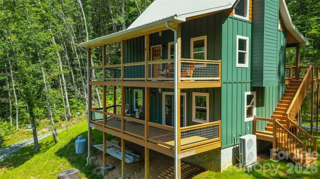 a view of a house with a window and wooden fence
