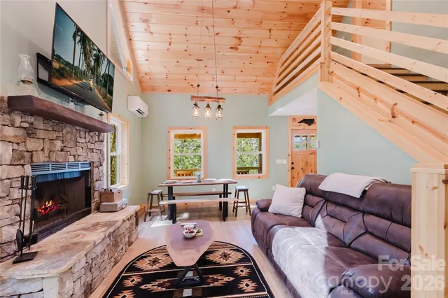 a living room with furniture a fireplace and a large window