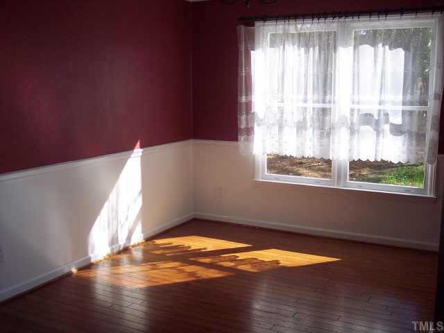 3612 Tunas Street Raleigh, NC 27616 - Photo 3 of 8 a view of empty room with wooden floor and fan