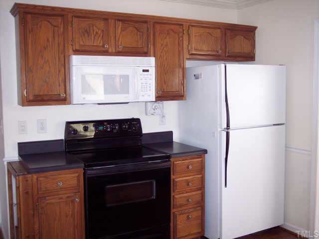 3612 Tunas Street Raleigh, NC 27616 - Photo 5 of 8 a kitchen with a refrigerator and a stove