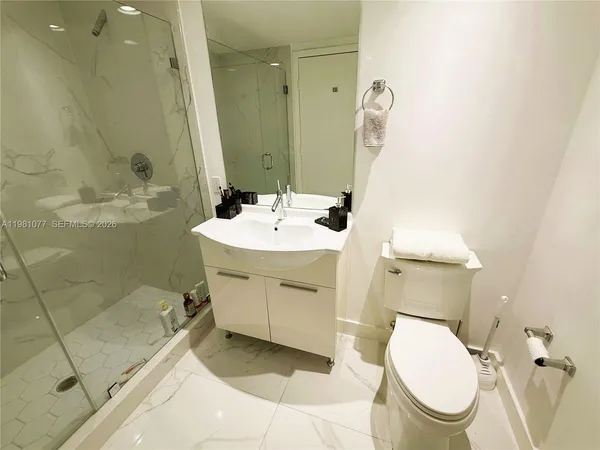 a bathroom with a sink a toilet and mirror