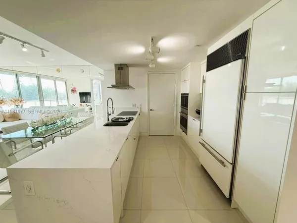 a kitchen with stainless steel appliances a refrigerator and a stove