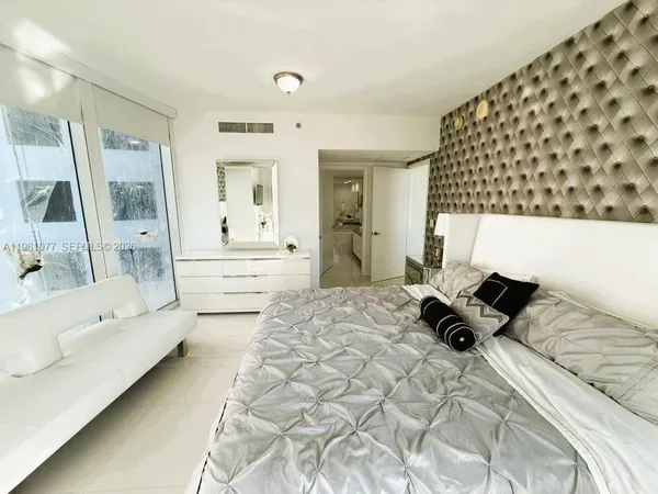 a bedroom with a bed and a couch