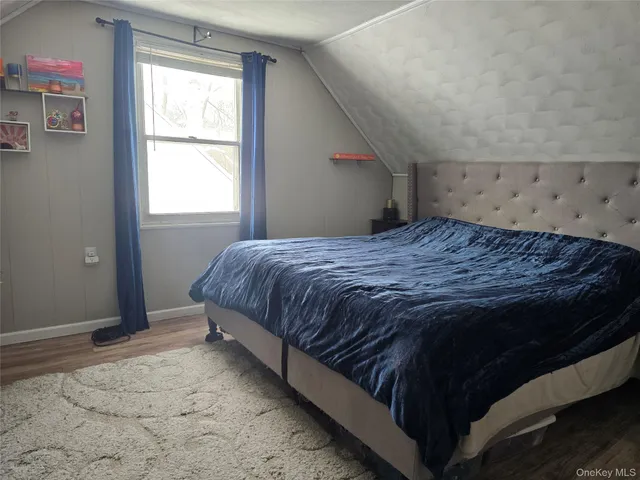 a bed sitting in a bedroom next to a window