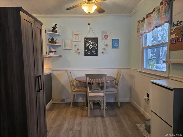 a dining room with furniture and window