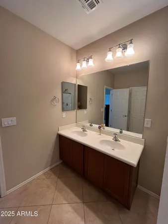 a bathroom with a sink vanity and mirror