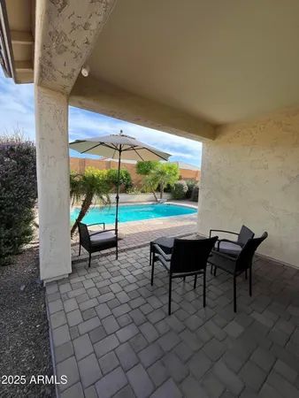 an outdoor sitting area with couch and wooden floor