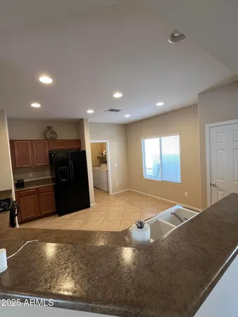 a view of kitchen with refrigerator and microwave