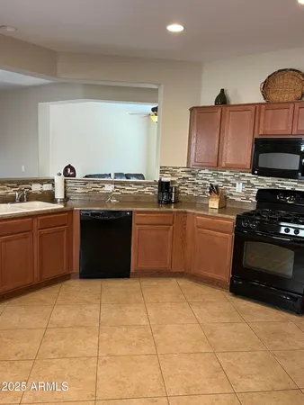a kitchen with stainless steel appliances granite countertop a stove sink and cabinets