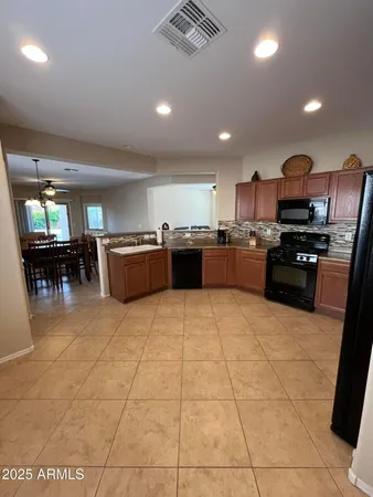 a large kitchen with lots of counter space and stainless steel appliances