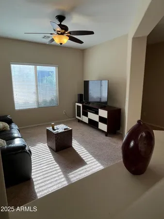 a living room with furniture and a air conditioner vent