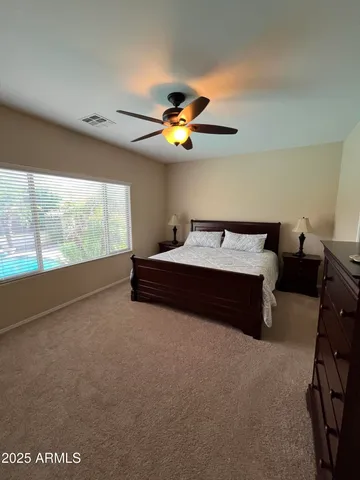 a bed room with a bed and a chandelier