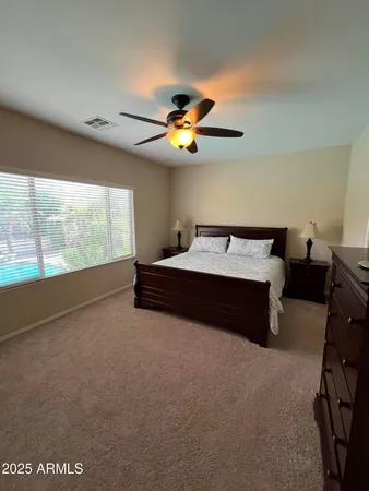 a bed room with a bed and a chandelier