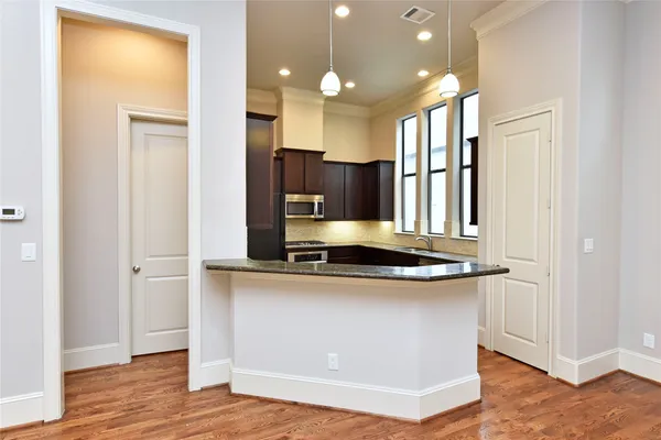 a kitchen with stainless steel appliances granite countertop a sink stove and refrigerator