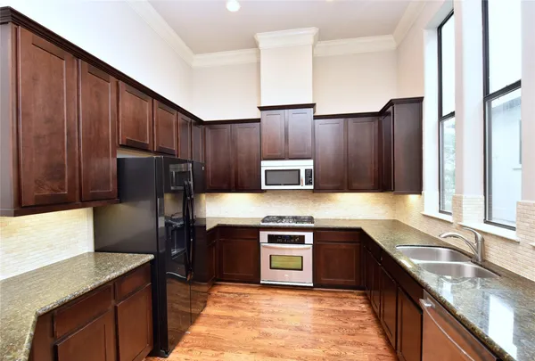 a kitchen with a sink stove and microwave