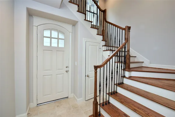 a view of staircase with wooden floor and a rug