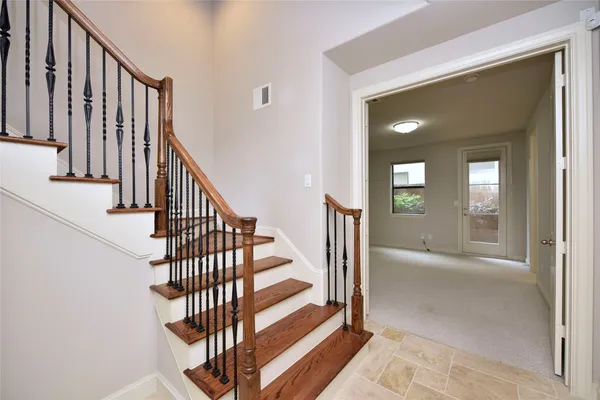 a view of entryway and hall with wooden floor