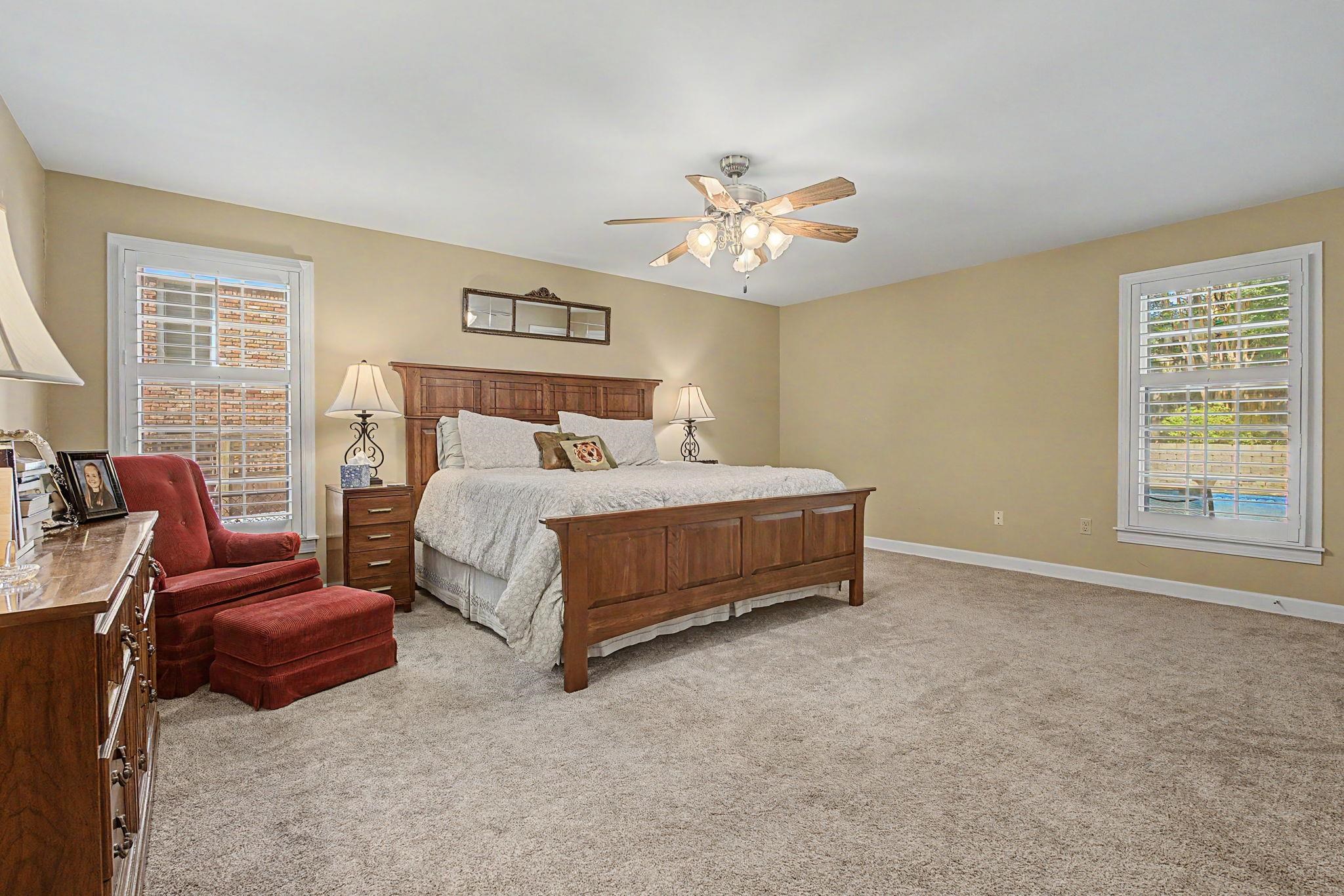 1929 Miller Farms Road Germantown, TN 38138 - Photo 16 of 40 Spacious room featuring neutral carpeting, a ceiling fan with light fixture, and two windows with white plantation shutters