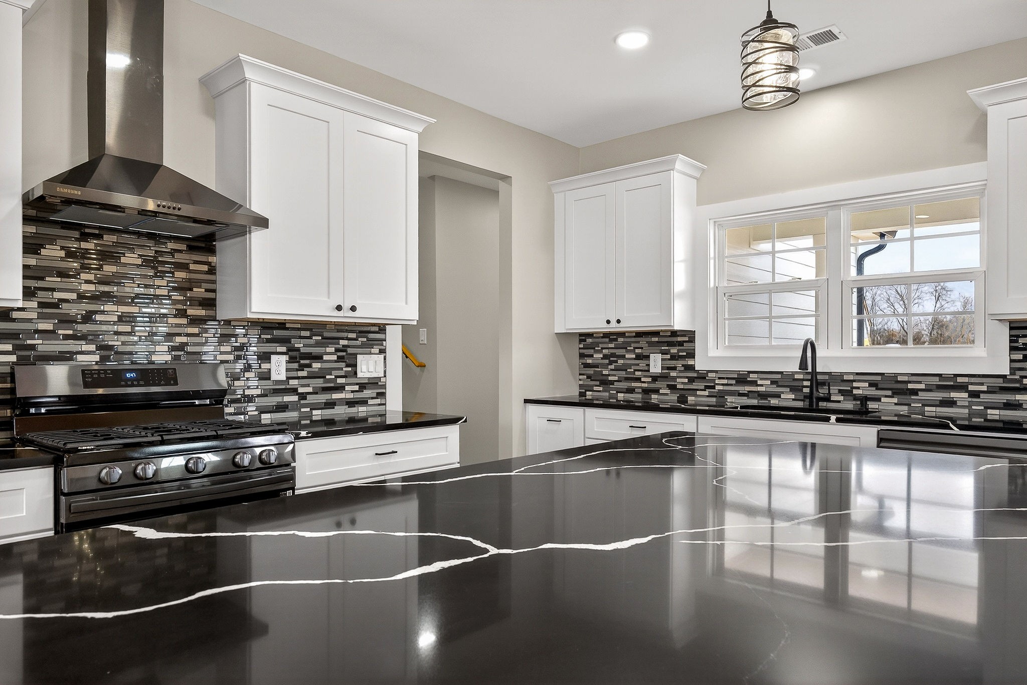 6955 Sweet Magnolia Way Baxter, TN 38544 - Photo 16 of 53 a kitchen with stainless steel appliances a stove a sink and a refrigerator