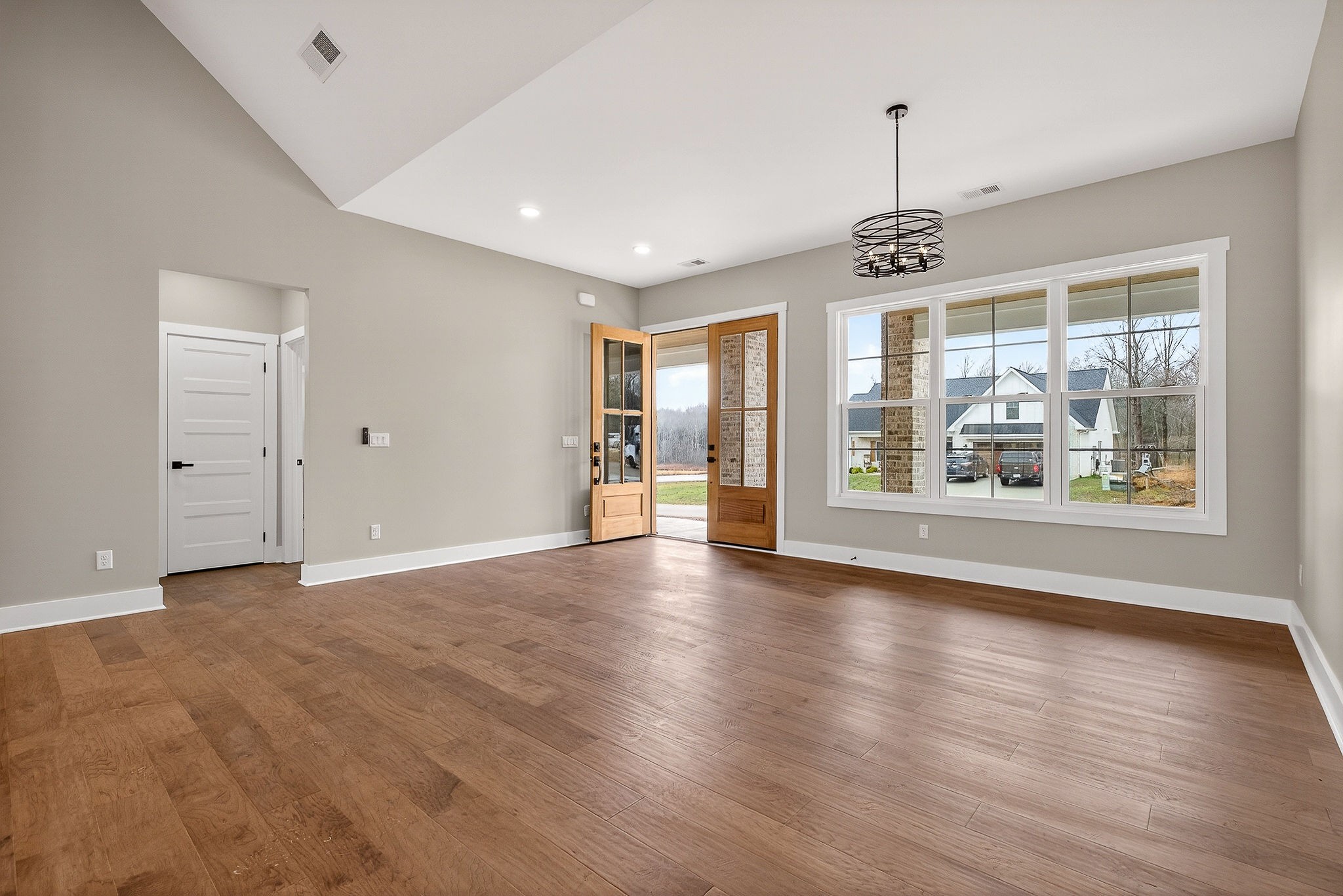 6955 Sweet Magnolia Way Baxter, TN 38544 - Photo 17 of 53 a view of an empty room with wooden floor and a window