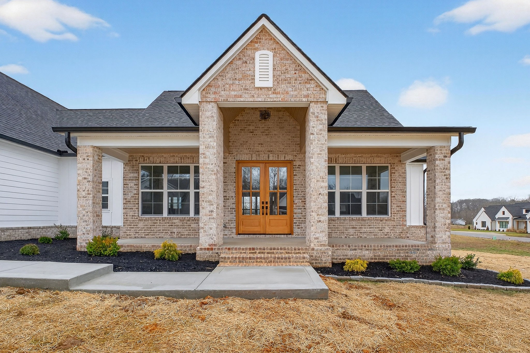 6955 Sweet Magnolia Way Baxter, TN 38544 - Photo 24 of 53 a front view of a house with garden