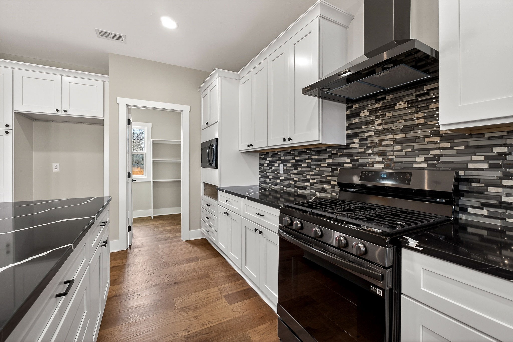 6955 Sweet Magnolia Way Baxter, TN 38544 - Photo 27 of 53 a kitchen with granite countertop a stove and a sink
