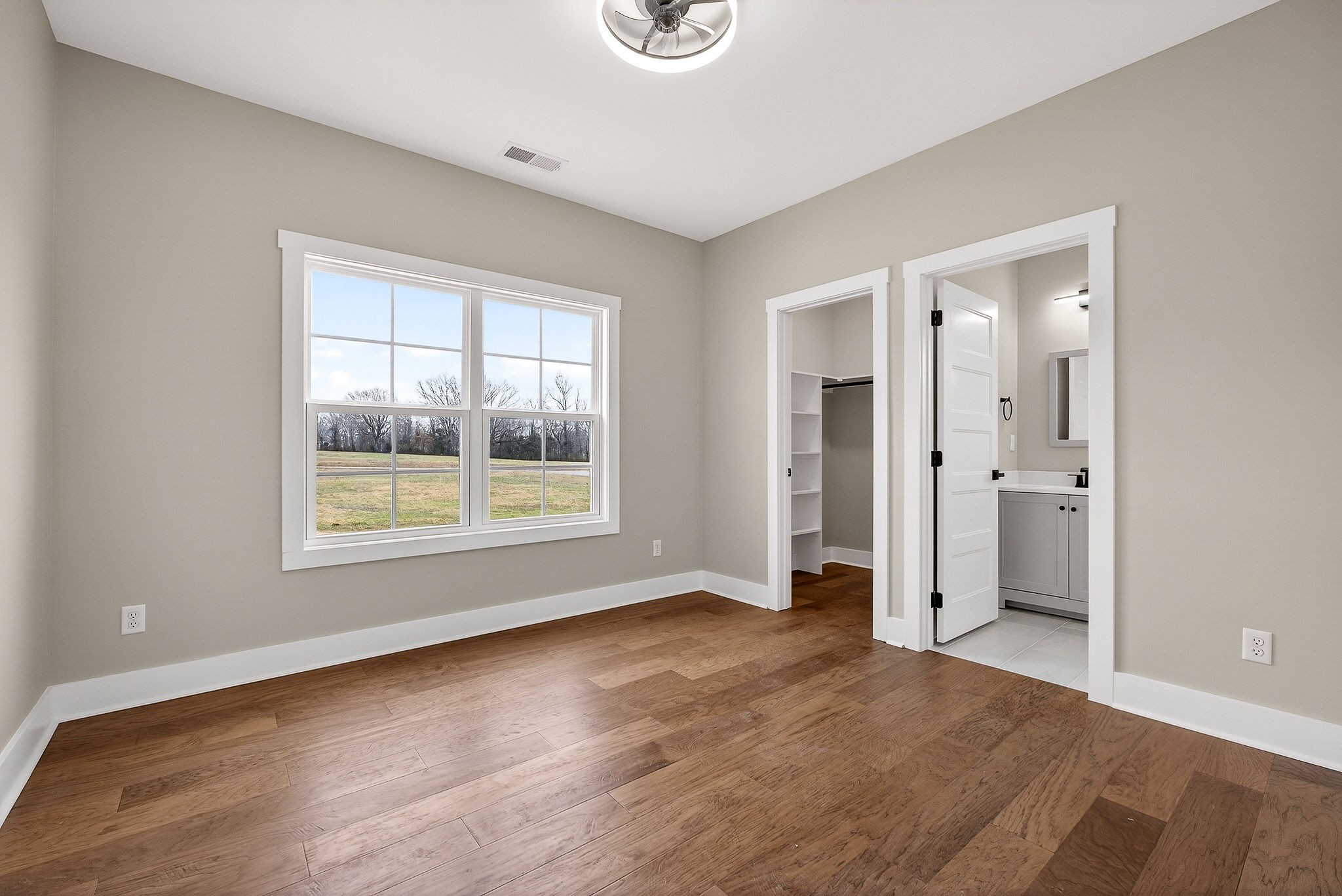 6955 Sweet Magnolia Way Baxter, TN 38544 - Photo 35 of 53 a view of an empty room with wooden floor and a window