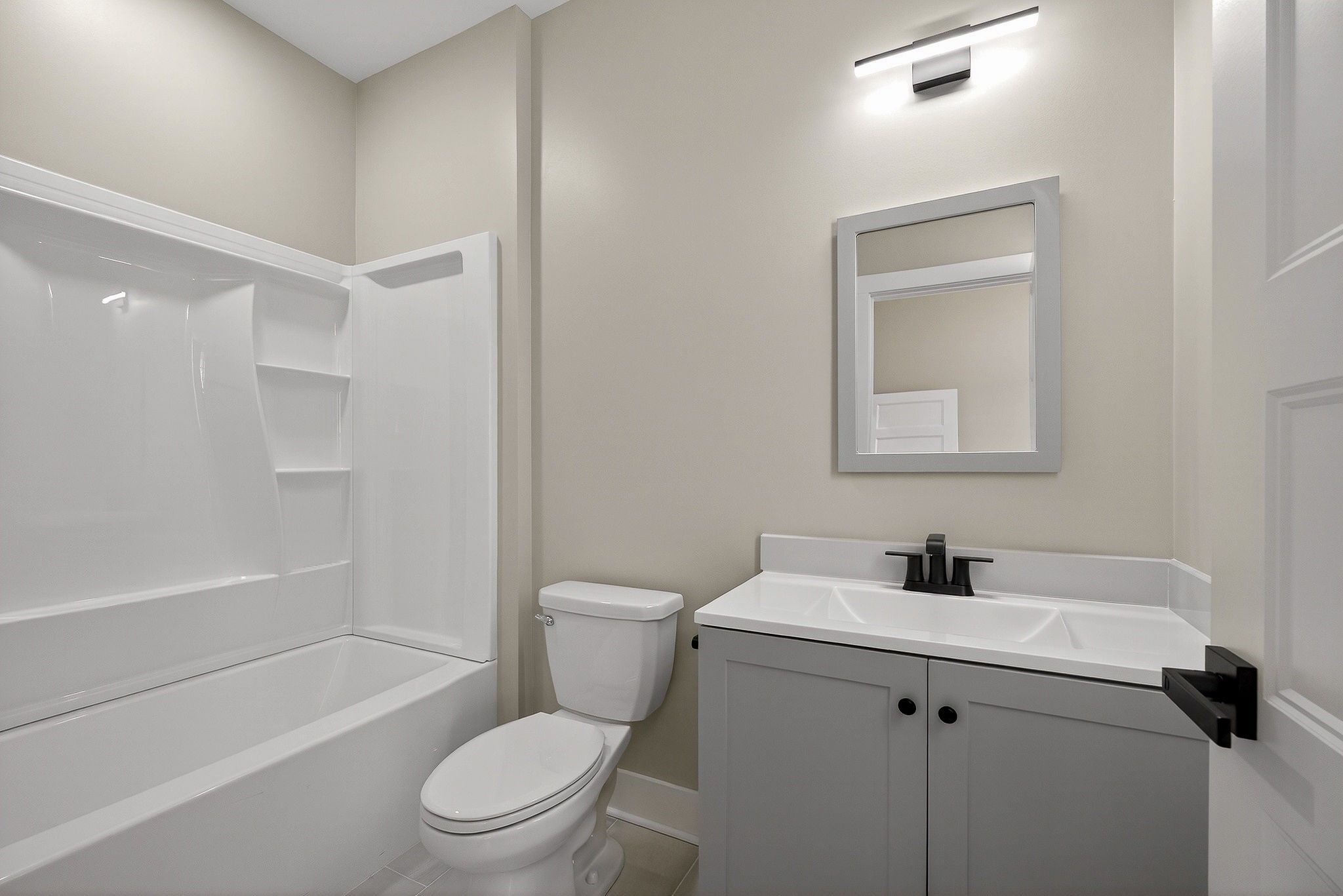 6955 Sweet Magnolia Way Baxter, TN 38544 - Photo 38 of 53 a white toilet sitting next to a bath tub
