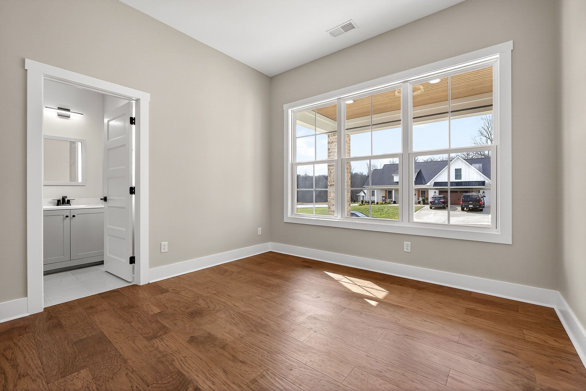6955 Sweet Magnolia Way Baxter, TN 38544 - Photo 40 of 53 a view of an empty room with a window and wooden floor