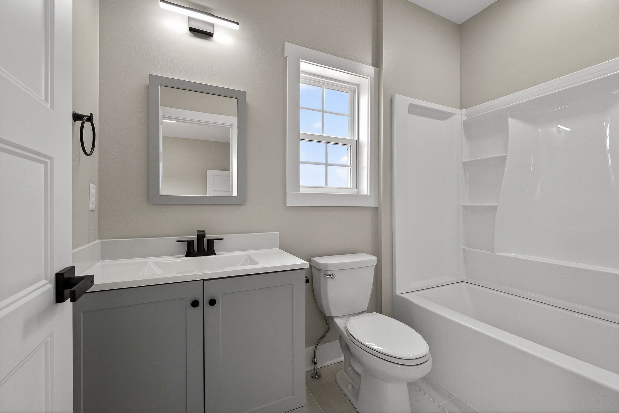 6955 Sweet Magnolia Way Baxter, TN 38544 - Photo 42 of 53 a white toilet sitting next to a bathroom sink