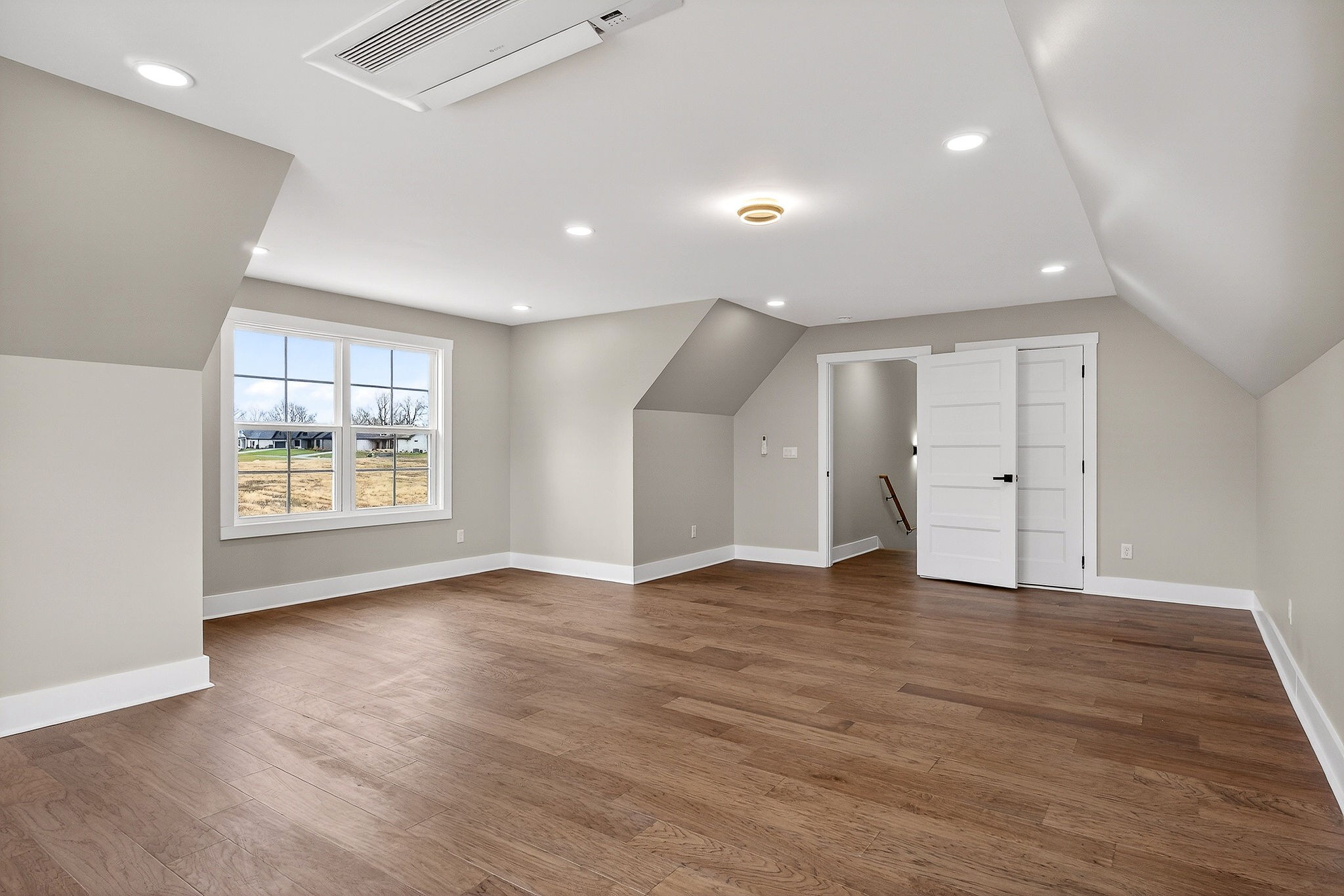 6955 Sweet Magnolia Way Baxter, TN 38544 - Photo 46 of 53 an empty room with wooden floor and windows