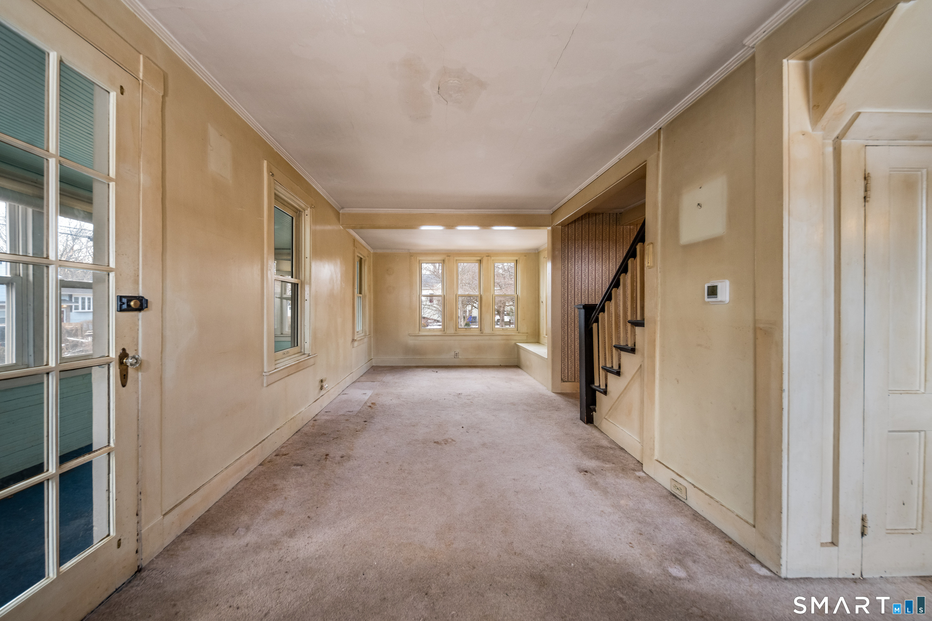 38 Grove Street Branford, CT 06405 - Photo 11 of 20 a view of a hallway with wooden shelves and windows