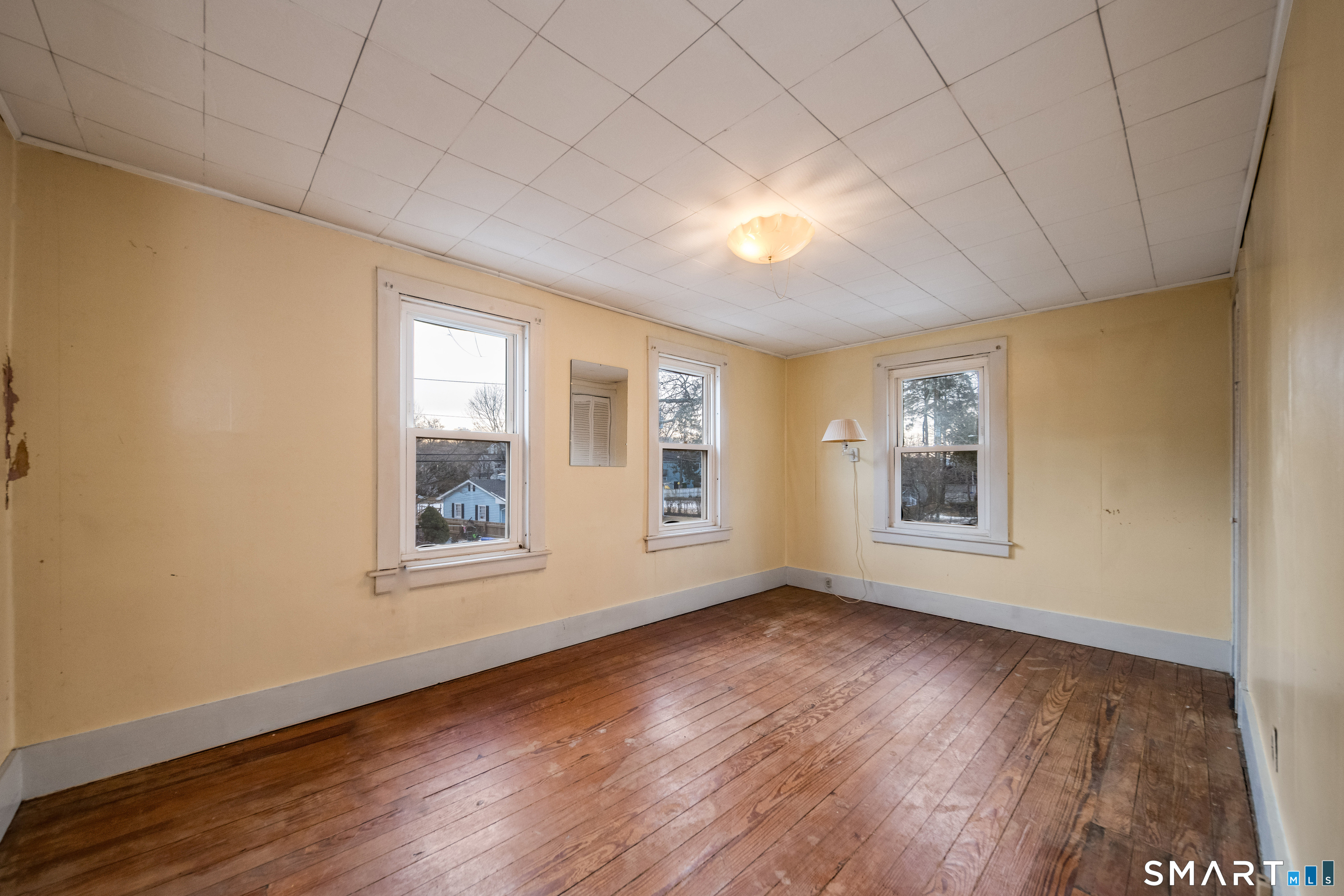 38 Grove Street Branford, CT 06405 - Photo 14 of 20 a view of an empty room with wooden floor and a window