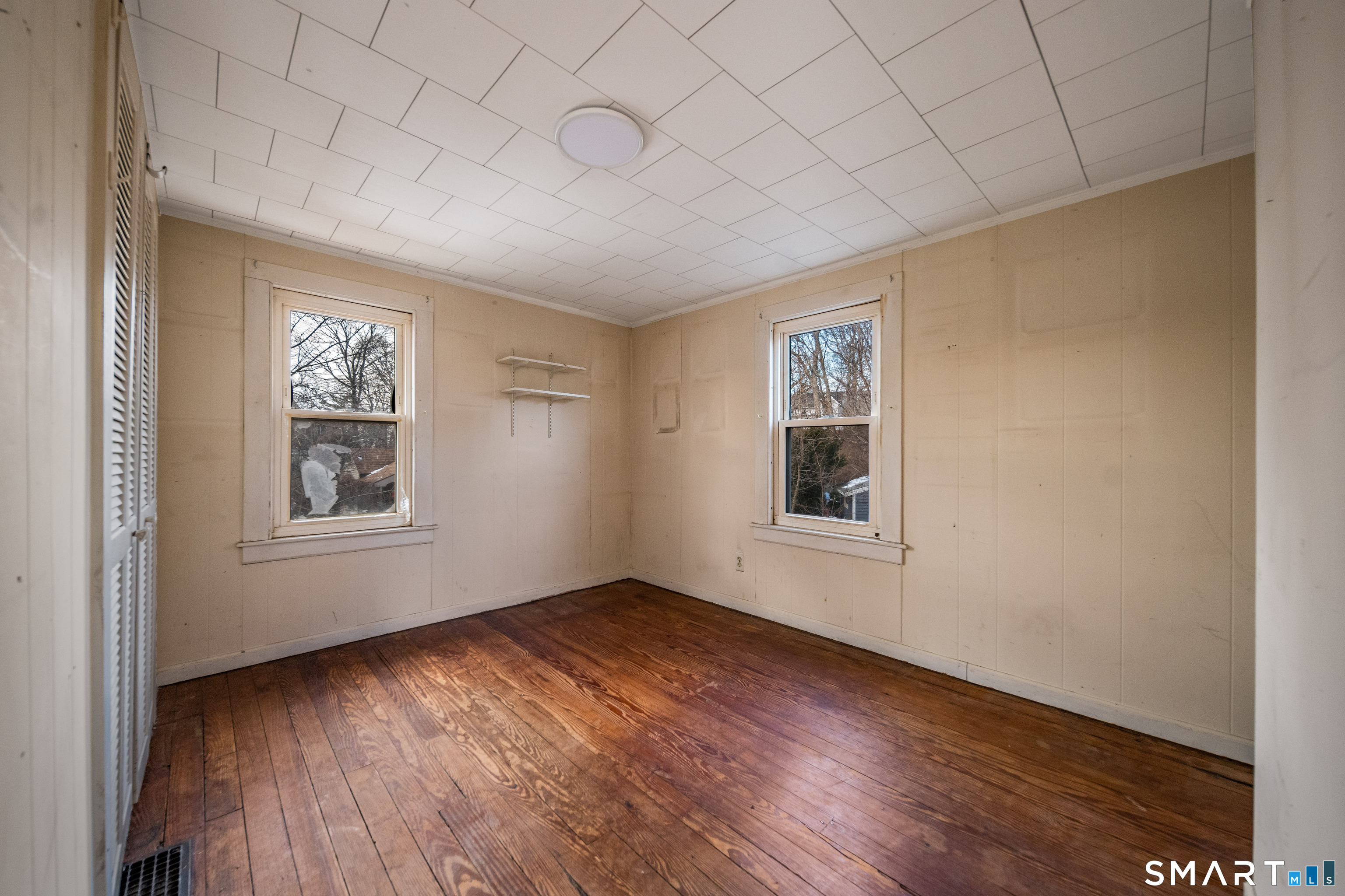 38 Grove Street Branford, CT 06405 - Photo 15 of 20 a view of an empty room with wooden floor and a window
