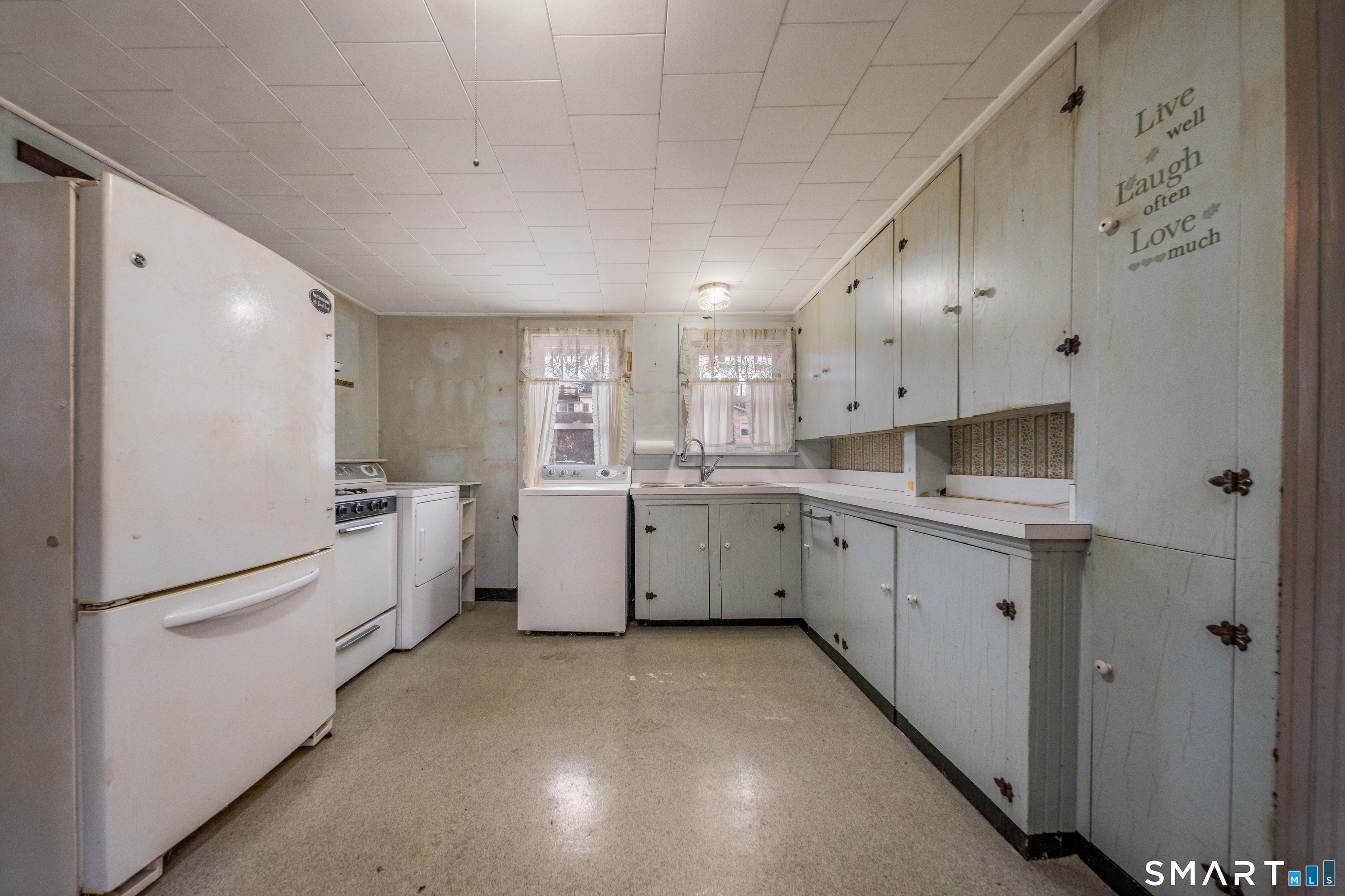 38 Grove Street Branford, CT 06405 - Photo 4 of 20 a kitchen with white cabinets and white appliances