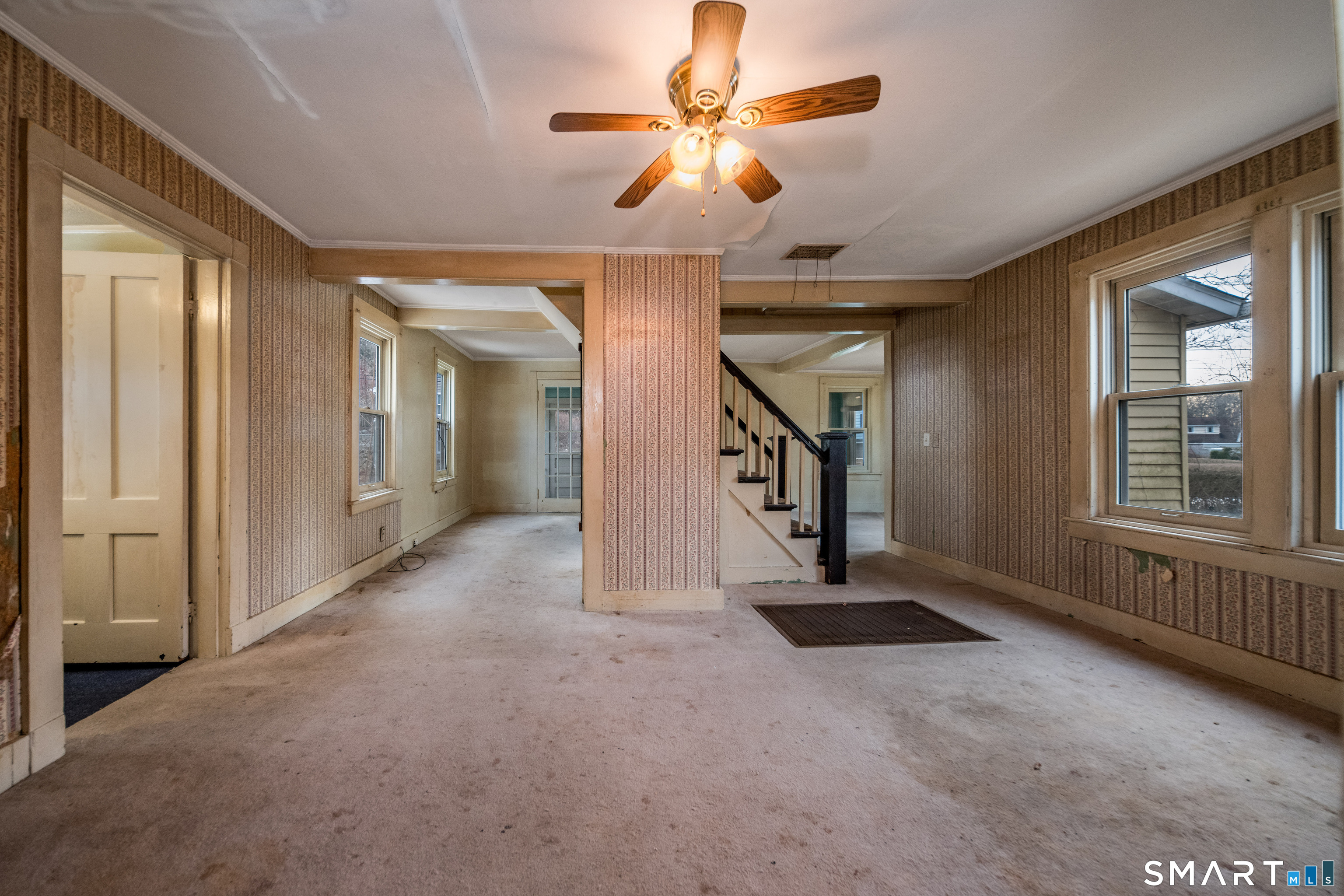 38 Grove Street Branford, CT 06405 - Photo 7 of 20 a view of a livingroom with a ceiling fan and window
